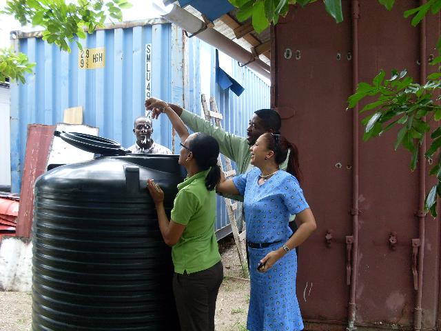 Jam1 project team and PA checking the harvested water during a site viist