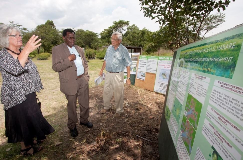 The COSMO Committee members showing Anada Tiega (in the middle) their awareness-raising displays